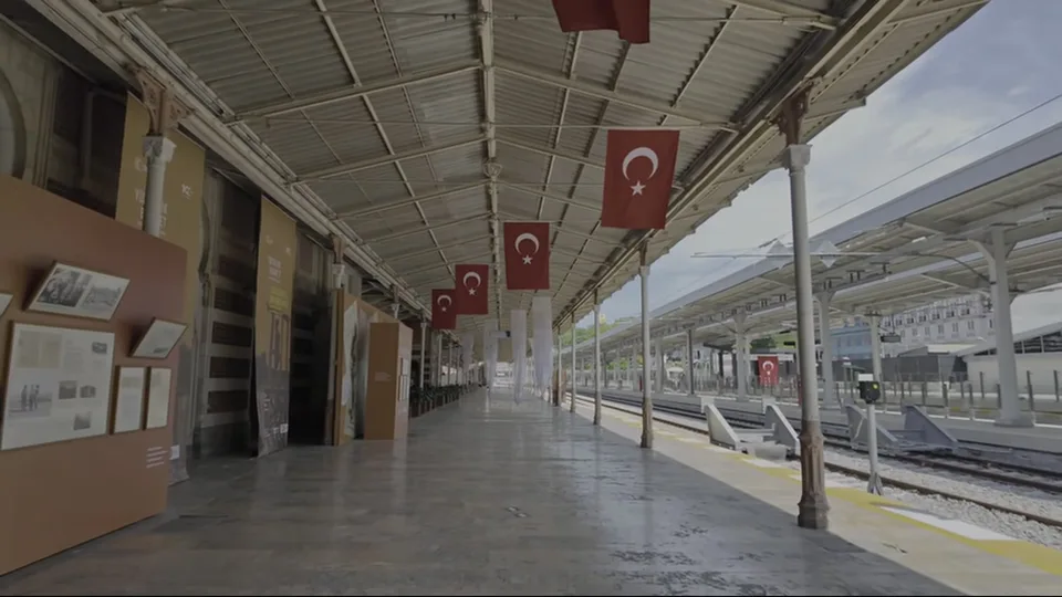 Historic red tram on Istiklal Avenue beside shops and pedestrians
