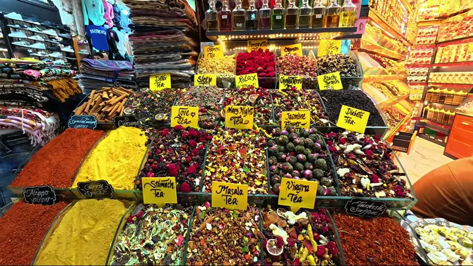 Grand Bazaar corridor with Turkish flags, jewelry cases, and evil-eye ornaments