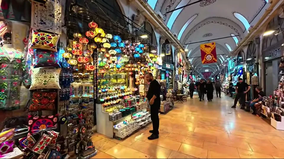 Centered rug shop scene with carpets and seating in the Grand Bazaar
